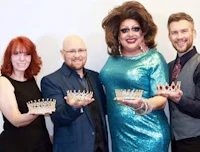 four people posing with crowns in front of a white background