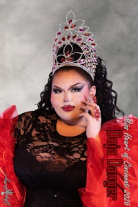 a woman in a red dress posing with a tiara