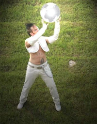 a man holding a silver ball in his hands